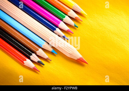 Red pencil standing out from a bunch of colored pencils, leadership concept Stock Photo
