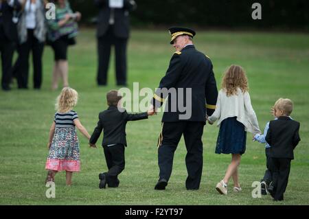 Arlington, Virginia, USA. 25th Sep, 2015. U.S. Army Gen. Martin E. Dempsey walks off Summerall Field with his grandchildren following his retirement and change of responsibility ceremony at Joint Base Myer-Henderson Hall September 25, 2015 in Arlington, Virginia. Gen. Dempsey retires from the military after 41 years in service and is succeeded by Marine Gen. Joseph Dunford. Stock Photo
