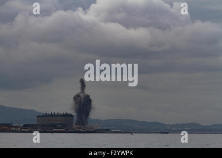 Cockenzie, Scotland, UK. 26th Sep, 2015. Demolition of the two 149m high chimneys of the coal-fired power station at Cockenzie, on the shores of the Firth of Forth near Edinburgh, Scotland, UK. The power station was opened in 1967 and was decomissioned in March 2013. The chimney stacks were brought down by controlled explosion at noon on 26th September 2015. Credit:  FeedStock/Alamy Live News Stock Photo