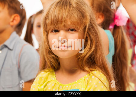 Little girl stand in the large group of friends Stock Photo