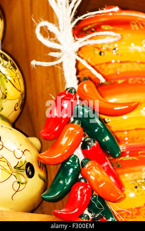 Brightly painted ceramic peppers display Stock Photo