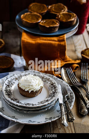 Mini pumpkin pie on a Festive Thanksgiving table. Stock Photo