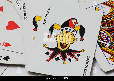 Joker on top of playing cards Stock Photo