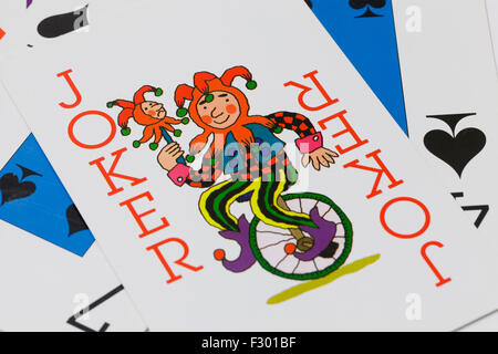 Joker on top of playing cards Stock Photo
