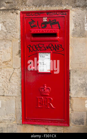 Graffitiied / vandalised / Graffiti on Queen Elizabeth ll wall mounted post box / letterbox / pillarbox posting box in Oxford UK Stock Photo