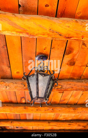 Old fashioned lantern hanging from a wooden ceiling Stock Photo