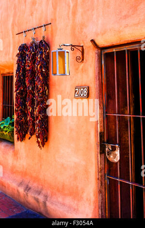 Rista's hanging up outside an adobe home in the Old Town part of Albuquerque NM Stock Photo