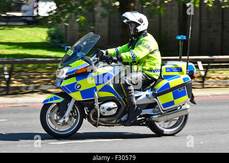 Metropolitan Police officer in high vis jacket patrolling on a BMW motorbike in Park Lane London England UK Stock Photo