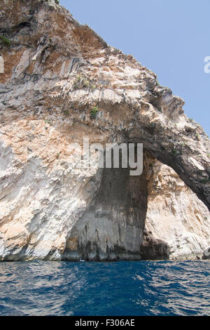 Limestone rocks with caves and clear turquoise water of popular tourist attraction Blue Grotto on a sunny day in September. Stock Photo