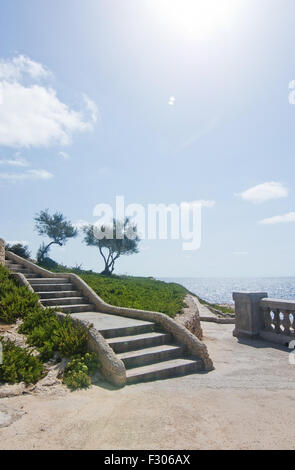 Park with trees and stairs coastal viewpoint near popular tourist attraction Blue Grotto on a sunny day in September. Stock Photo