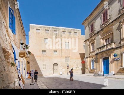 Local police station inside old city walls on a sunny day in September with tourists outside a souvenir shop in Mdina, Malta. Stock Photo