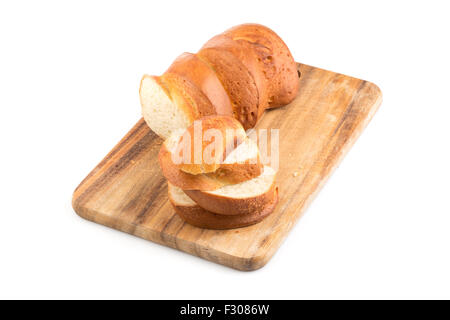 Sliced bread on a wooden chopping board isolated on a white Stock Photo