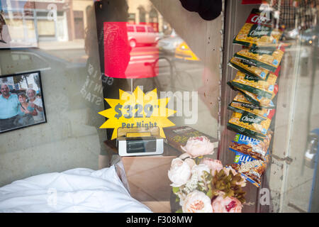 Brooklyn, New York, US. 26th Sep, 2015. The owners of Jesse's Deli in the Boerum Hill neighborhood of Brooklyn in New York have transformed their front window into an 'AirBnBodega' in protest against the 'yuppifying' of the neighborhood and their steep rent hike, seen on Saturday, September 26, 2015.  The owners settled on a price of $329 per night including snacks with an authentic employees bathroom.  (© Richard B. Levine) Credit:  Richard Levine/Alamy Live News Stock Photo
