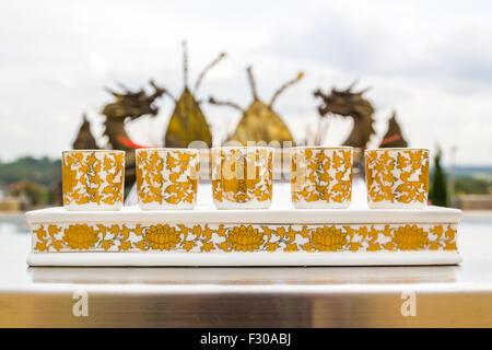 Set of chinese tea cup in dragon statue and sky background Stock Photo