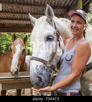 Woman at Na'alapa Stables in Waipio Valley on the Big Island of Hawaii Stock Photo