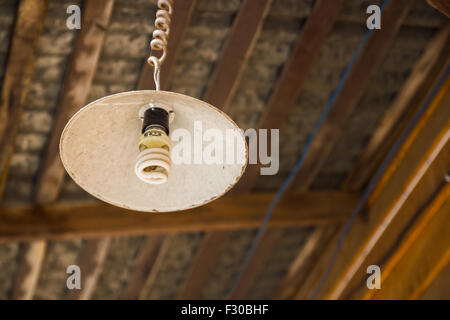 Old grunge lamp under the wooden ceiling Stock Photo