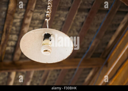 Old grunge lamp under the wooden ceiling Stock Photo