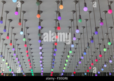 Installation of multi-colored light bulbs on the ceiling Stock Photo