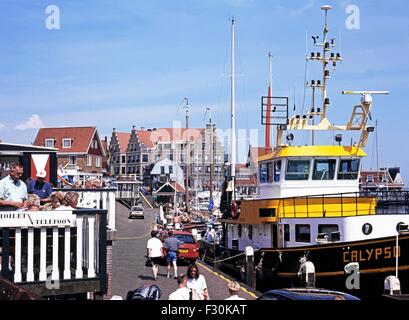 Tourists walking along the quayside shopping street during the Summertime, Volendam, Holland, Netherlands, Europe. Stock Photo