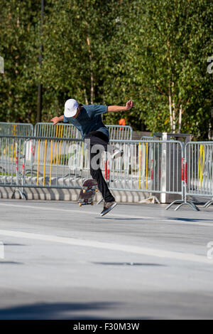 A Young lad performing tricks on his skateboard in a car park in Birmingham West Midlands UK Stock Photo