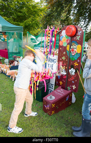 Soham, Cambrideshire, UK . 26th Sep, 2015. Boy swinging hammer playing ring the bell at Soham Pumpkin fair 2015 Credit:  Jason Marsh/Alamy Live News Stock Photo