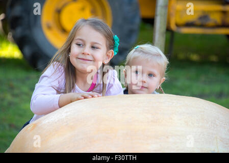 Soham, Cambrideshire, UK . 26th Sep, 2015. Girls looking at giant pumpkin at Soham Pumpkin fair 2015 Credit:  Jason Marsh/Alamy Live News Stock Photo