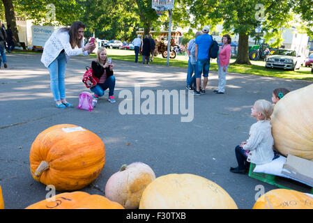 Soham, Cambrideshire, UK. 26th Sep, 2015. Proud mums photographing girls with giant pumpkins at Soham pumpkin fair 2015 Credit:  Jason Marsh/Alamy Live News Stock Photo