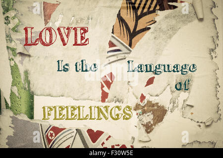 Love is the language of feelings - Inspirational message written on vintage grunge background with Old Torn Posters. Motivational concept image Stock Photo