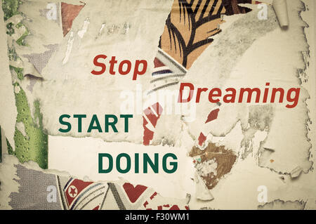 Stop Dreaming Start Doing - Inspirational message written on vintage grunge background with Old Torn Posters. Motivational concept image Stock Photo