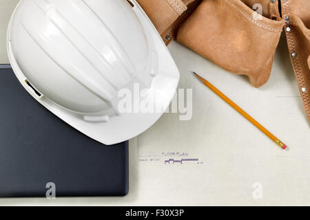 Top view close up of construction contractor tools on top of blue print drawings. Stock Photo