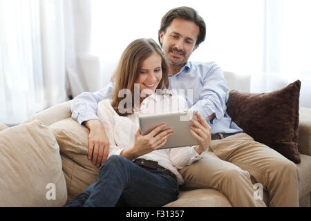 Cheerful couple using digital tablet at home Stock Photo