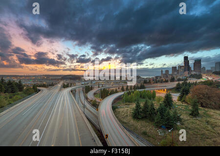 Colorful Sunset Over Seattle Washington City Skyline and Interstate Freeway Stock Photo