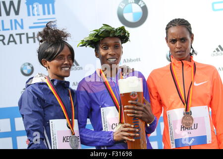 Berlin, Germany. 27th Sep, 2015. Gladys Cherono (center), Ethiopian Meseret Hailu (right) Aberu Kebede (left) pose with their awards ceremony during the 42 Berlin Marathon. Credit:  Simone Kuhlmey/Pacific Press/Alamy Live News Stock Photo