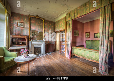 Dilapidated luxurious bedroom in an abandoned castle Stock Photo