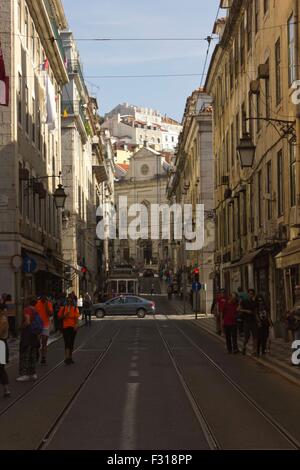 LISBON, PORTUGAL - OCTOBER 26 2014: Rua conceicao street in Lisbon, with Magdalene church in the background an people walking ar Stock Photo