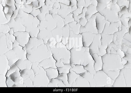 Cracked flaking white paint on the wall, background texture Stock Photo