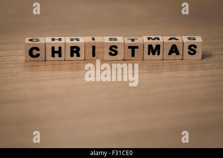 Christmas written in wooden cubes on a desk Stock Photo