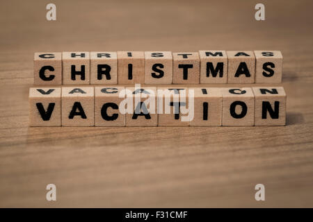 Christmas vacation written in wooden cubes on a desk Stock Photo