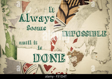 It Always Seems Impossible Until It Is Done - Inspirational message written on vintage grunge background with Old Torn Posters. Motivational concept image Stock Photo