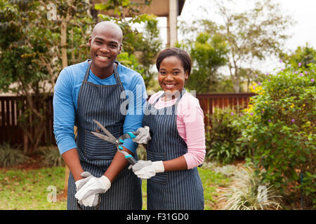 portrait of lovely African American couple standing in home garden Stock Photo