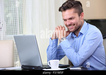 young businessman checks mail on the computer Stock Photo