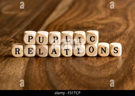 PUPLIC RELATIONS word background on wood blocks Stock Photo