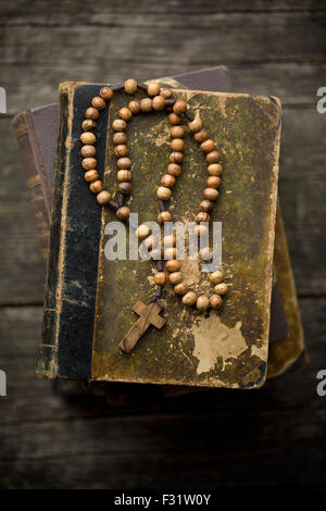 the vintage rosary beads on old book Stock Photo