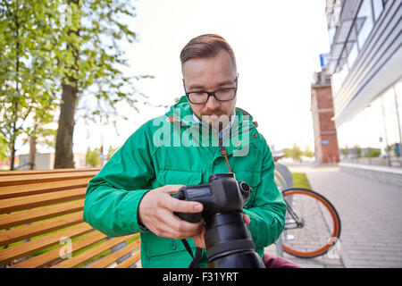 young hipster man with digital camera in city Stock Photo