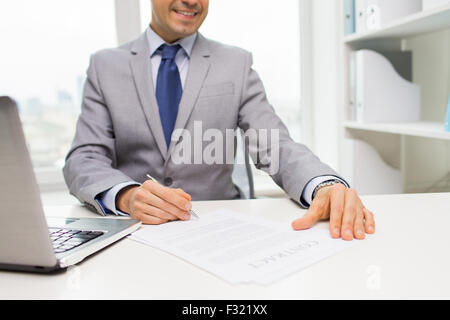 close up of businessman with laptop and papers Stock Photo