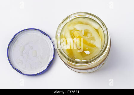 Glass jar of sliced lemons in lemon juice Stock Photo