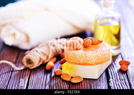 almond soap and oil on the wooden table Stock Photo