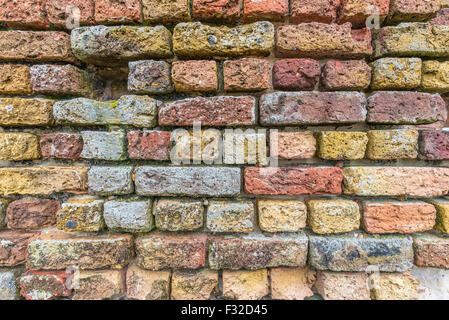 Very old weathered brick wall set in lime mortar Stock Photo