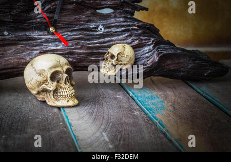 The skull and the clock on the old wooden Stock Photo