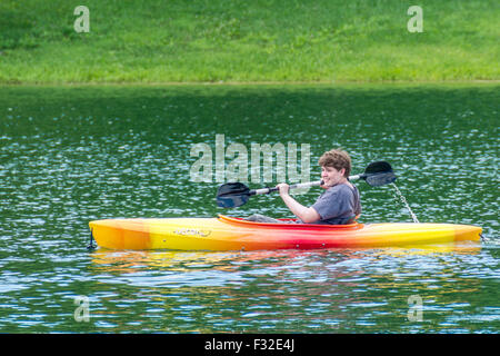 Teenage boy kayaking on a lake Stock Photo